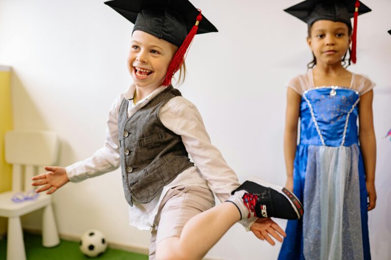 Children celebrating kindergarten graduation with vibrant outfits and joyful expressions.